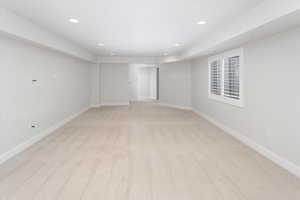 Spare room with recessed lighting, baseboards, and light colored carpet