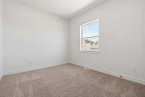 Spare room with baseboards, carpet flooring, and visible vents