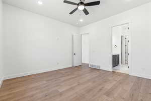 Unfurnished bedroom with visible vents, light wood-style floors, baseboards, recessed lighting, and connected bathroom