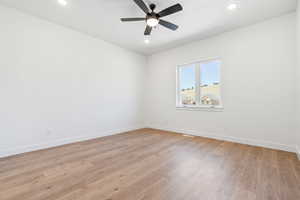Empty room featuring recessed lighting, baseboards, ceiling fan, and light wood finished floors