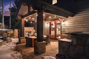 View of patio featuring an outdoor stone fireplace