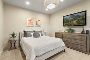 Bedroom with baseboards, recessed lighting, and light carpet