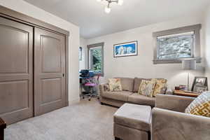 Carpeted living area with baseboards