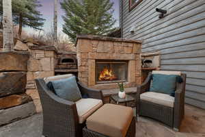 View of patio featuring an outdoor stone fireplace