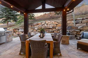 View of patio featuring a gazebo, outdoor dining area, and a grill