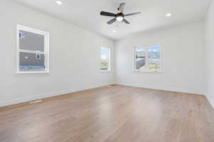 Unfurnished room with light wood-type flooring, recessed lighting, baseboards, and ceiling fan