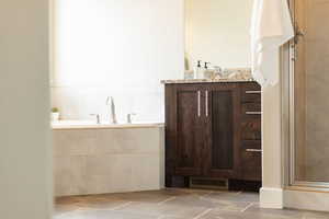 Full bathroom with vanity, tile patterned floors, a stall shower, and visible vents