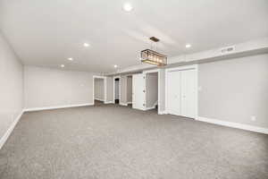 Finished basement featuring recessed lighting, baseboards, visible vents, and carpet