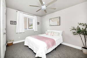 Bedroom featuring baseboards, a ceiling fan, and carpet floors