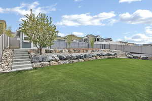 View of yard featuring a fenced backyard and a residential view
