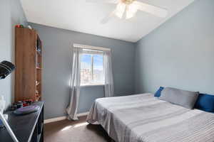 Carpeted bedroom with baseboards and a ceiling fan