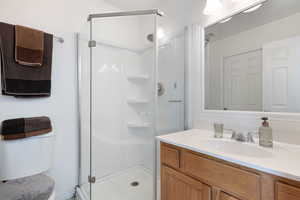 Full bath with vanity and a stall shower