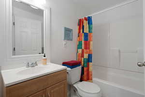 Bathroom featuring toilet, visible vents, shower / bath combo, and vanity
