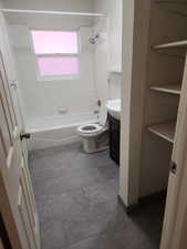 Full bath with toilet, vanity, and shower / washtub combination