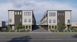 View of building exterior featuring uncovered parking