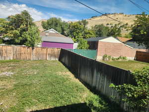 View of yard featuring a mountain view and a fenced backyard