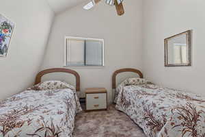 Bedroom with a ceiling fan, high vaulted ceiling, carpet, and a baseboard radiator