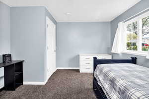 Bedroom featuring baseboards and carpet