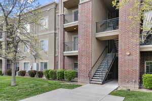 View of property with central AC and stairs
