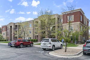 View of building exterior with uncovered parking
