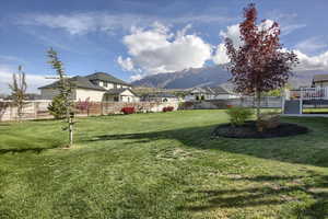 View of yard featuring fence and a mountain view