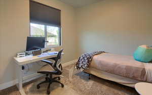 Carpeted bedroom featuring baseboards
