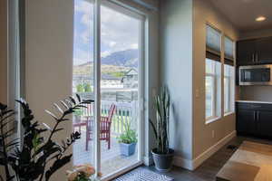 Entryway featuring baseboards, recessed lighting, a mountain view, and dark wood-style floors