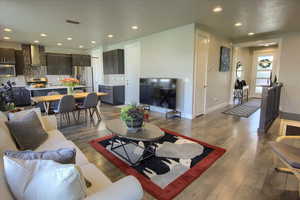 Living room with baseboards, recessed lighting, and hardwood / wood-style floors