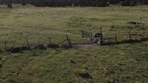 View of yard with fence and a rural view