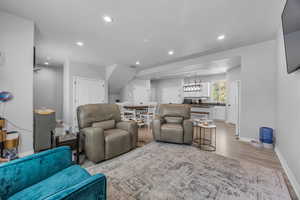 Living area with light wood-type flooring, recessed lighting, and baseboards