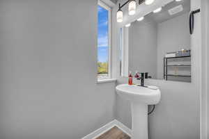 Bathroom with baseboards and wood finished floors