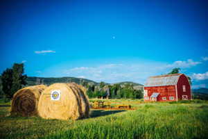 Community sign with a rural view and a mountain view