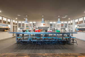 Bar with dark tile patterned flooring, recessed lighting, decorative light fixtures, and visible vents