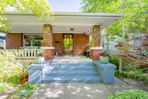 Large, covered front porch with seating and string lights