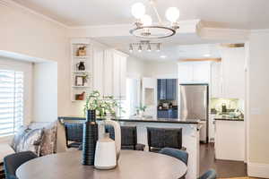 Dining space opens to the kitchen and front living room.  Large bench seat under window and bar seating with tons of natural light.