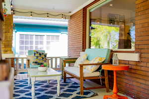 Large, covered front porch with seating and string lights