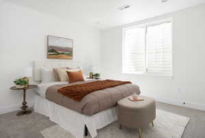 Bedroom with carpet floors, baseboards, and visible vents