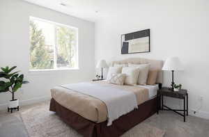 Bedroom featuring baseboards, carpet flooring, and visible vents