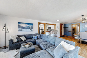 Living area featuring wood finished floors and a textured ceiling
