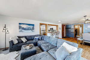 Living room with wood finished floors and a textured ceiling