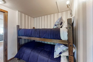 Bedroom with visible vents and a textured ceiling