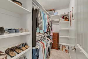 Primary bedroom walk in closet