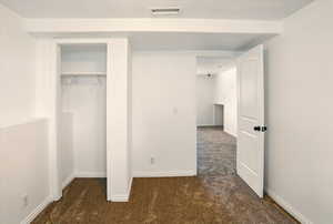 Unfurnished bedroom featuring visible vents, carpet flooring, baseboards, and a closet