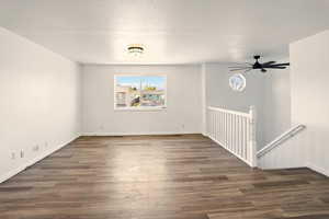 Spare room with baseboards, ceiling fan, and wood finished floors