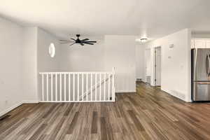 Interior space featuring visible vents, baseboards, and dark wood-type flooring