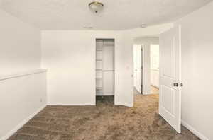 Unfurnished bedroom with carpet floors, baseboards, a closet, and visible vents