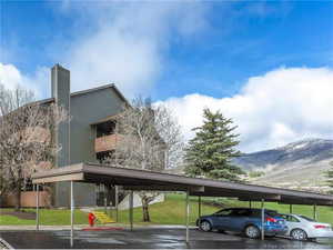 Covered parking lot featuring a mountain view