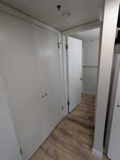 Hallway with wood finished floors