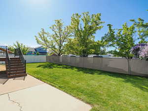 View of yard featuring a fenced backyard, stairs, a patio area, and a deck