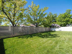 View of yard featuring fence